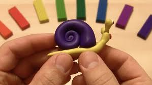 Professional plasticine sculpting artist creating detailed figurine in bright studio environment